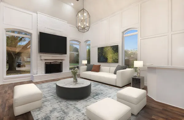 a living room with furniture a fireplace and a flat screen tv