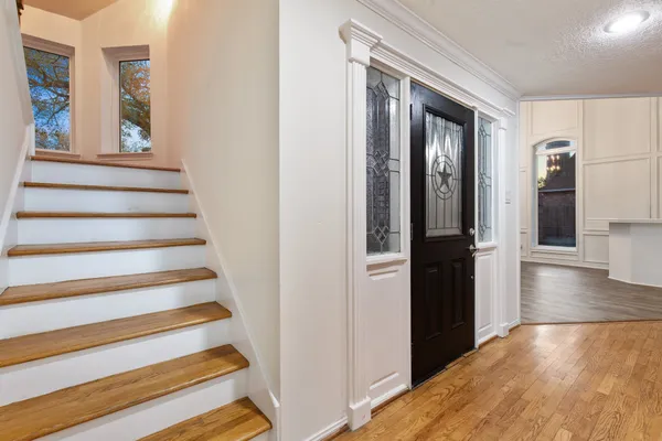 a view of entryway and hall with wooden floor