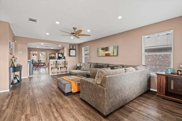 a living room with furniture and a wooden floor