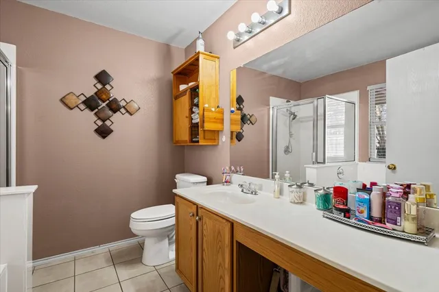 a bathroom with a sink vanity mirror and toilet