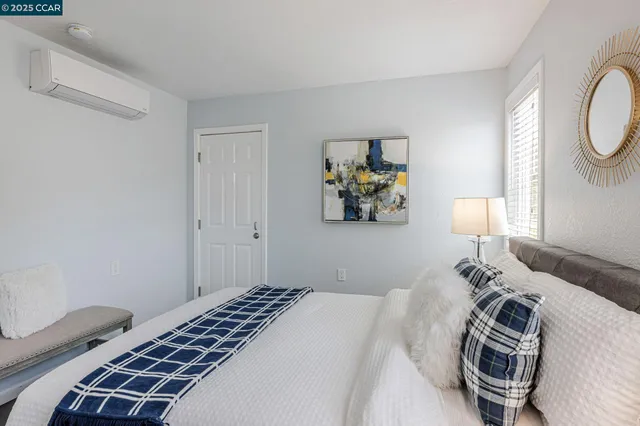 a bedroom with a bed and a lamp