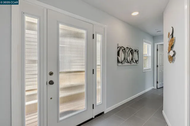 a view of a hallway with wooden floor and entryway
