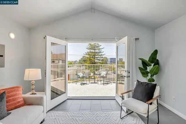 a view of a chairs and table on the roof deck