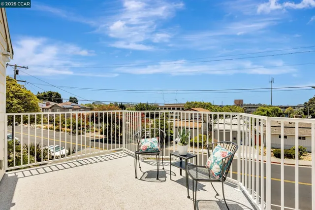 a view of a balcony with a potted plants and wooden floor