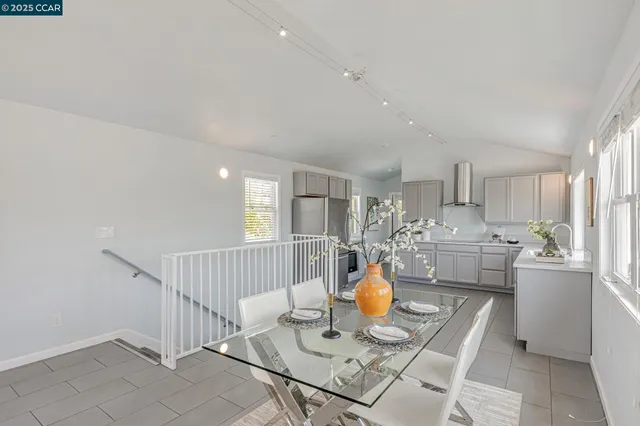 a kitchen with refrigerator and cabinets