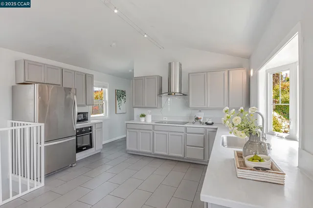 a kitchen with stainless steel appliances white cabinets and a sink