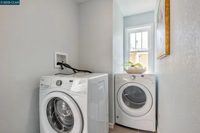 a view of a patio with a table and chairs and potted plants