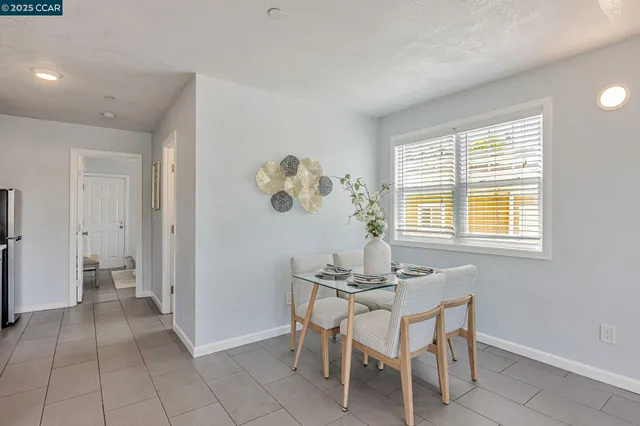 a dining room that has a window and a table in it