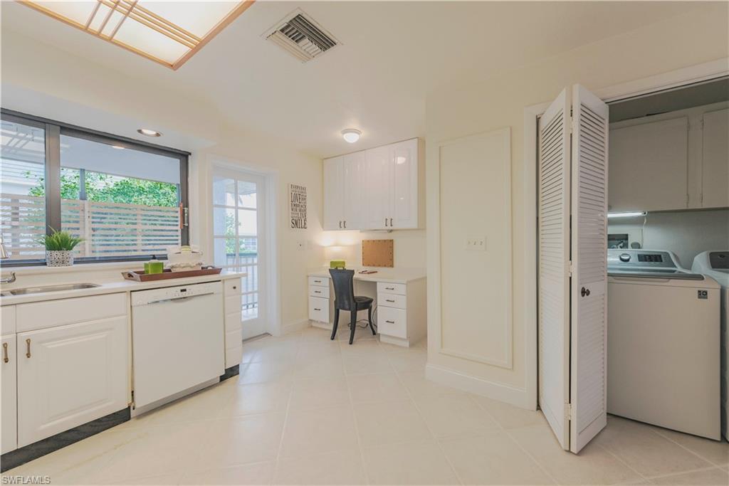 3107 Riviera Drive, Unit A202 Naples, FL 34103 - Photo 11 of 25 a kitchen with sink cabinets and window