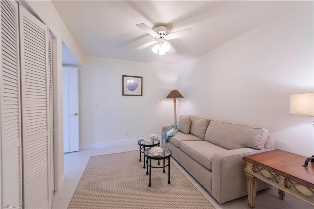 3107 Riviera Drive, Unit A202 Naples, FL 34103 - Photo 16 of 25 a living room with furniture and a window