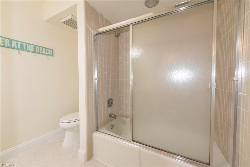 3107 Riviera Drive, Unit A202 Naples, FL 34103 - Photo 20 of 25 a bathroom with a shower and a toilet