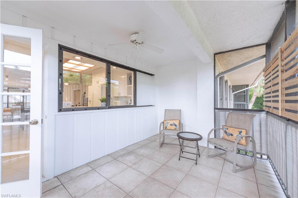 3107 Riviera Drive, Unit A202 Naples, FL 34103 - Photo 22 of 25 a living room with furniture and a window