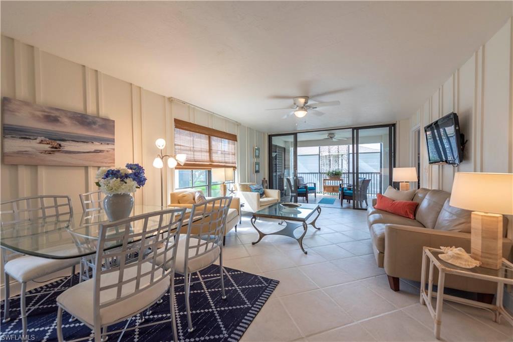 3107 Riviera Drive, Unit A202 Naples, FL 34103 - Photo 4 of 25 a living room with furniture and a window