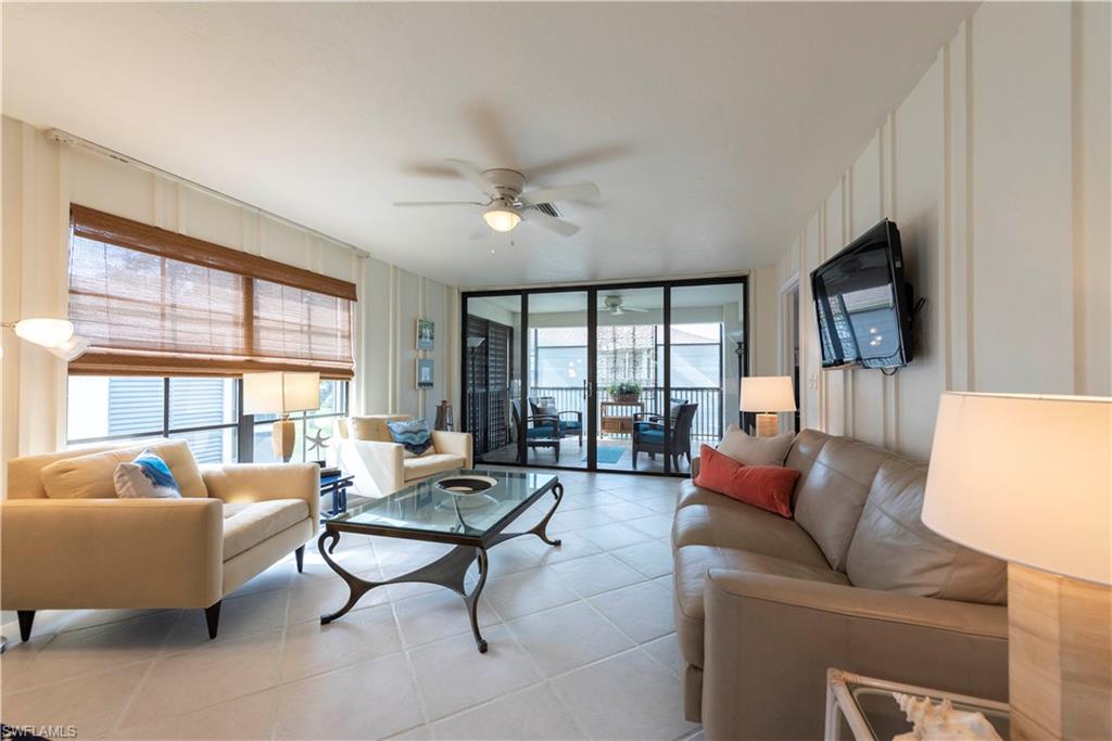 3107 Riviera Drive, Unit A202 Naples, FL 34103 - Photo 5 of 25 a living room with furniture and a large window