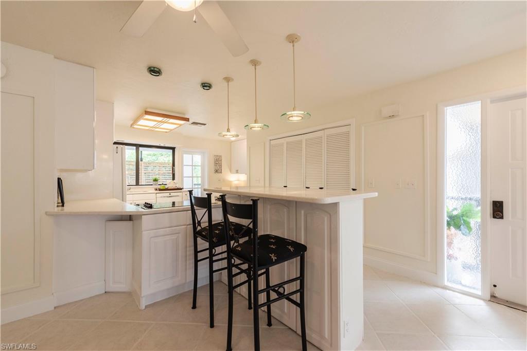 3107 Riviera Drive, Unit A202 Naples, FL 34103 - Photo 10 of 25 a view of a kitchen and dining room