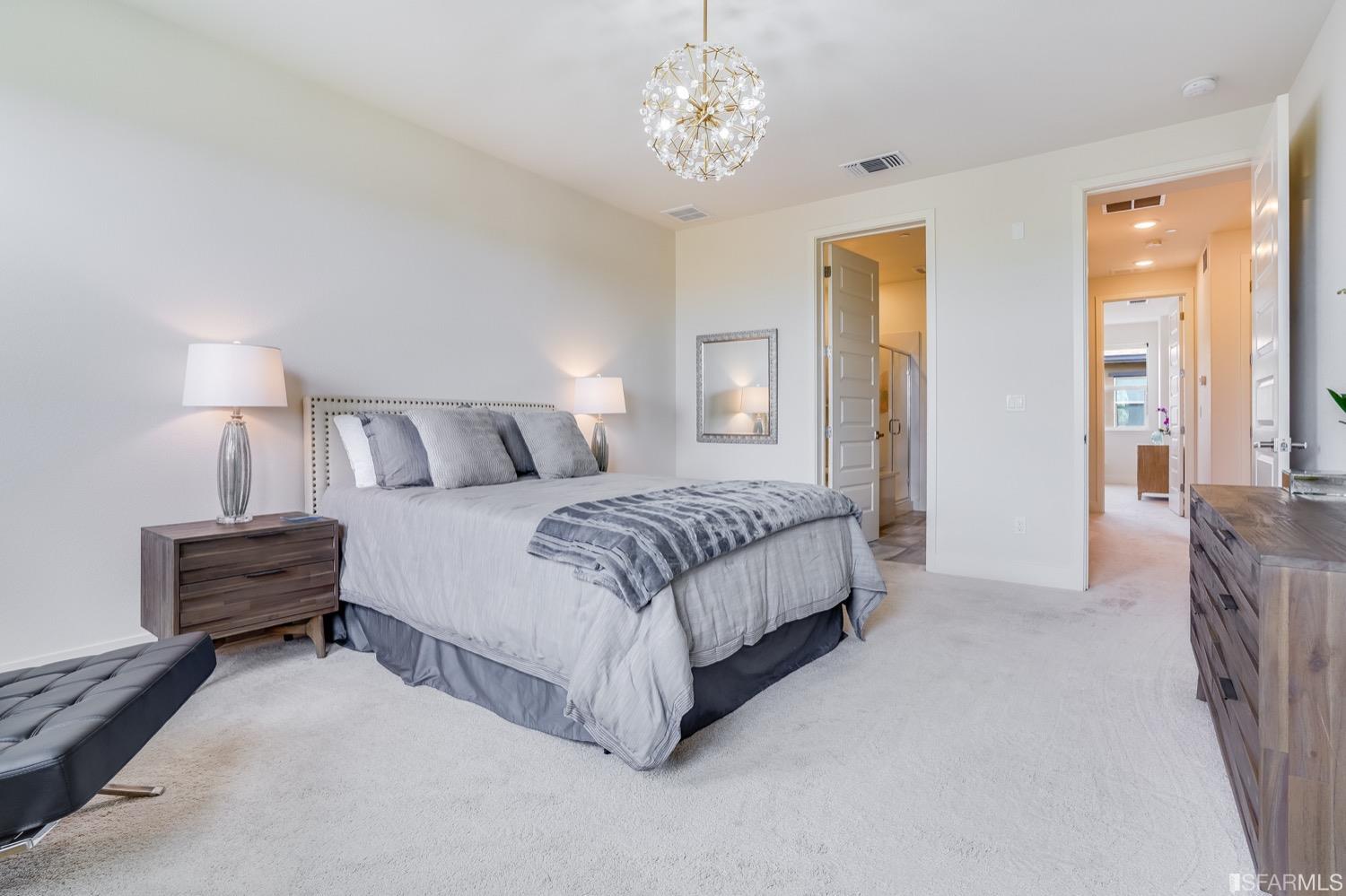 471 Mitchell Avenue Alameda, CA 94501 - Photo 31 of 50 a spacious bedroom with a bed and a chandelier
