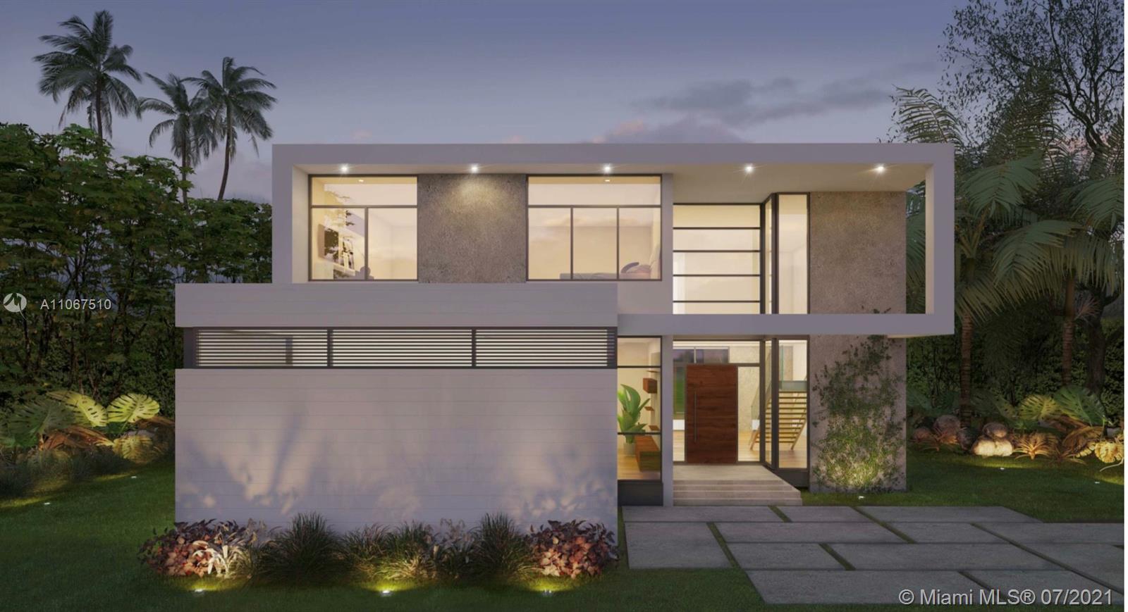 1230 Cleveland Road Miami Beach, FL 33141 - Photo 1 of 3 a front view of a house with a yard and a garden