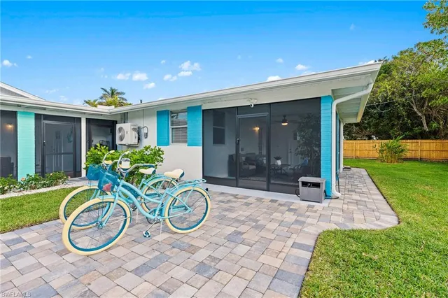 a view of a house with yard and furniture