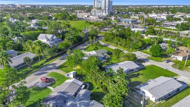 an aerial view of residential houses with outdoor space and trees