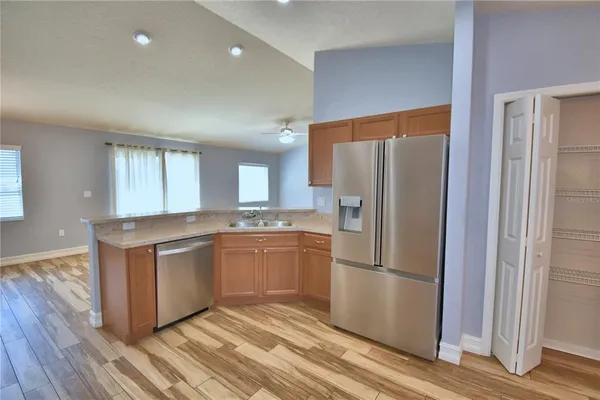 a view of a room with wooden floor and ceiling fan