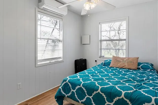 a bedroom with a large bed and a window