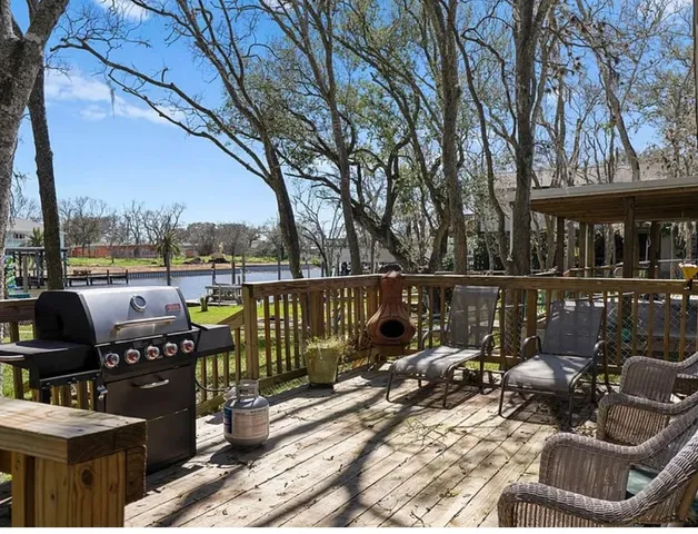 a view of a roof deck with couches and wooden floor