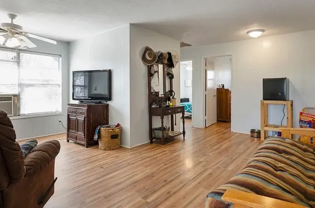 a bedroom with furniture and a flat screen tv
