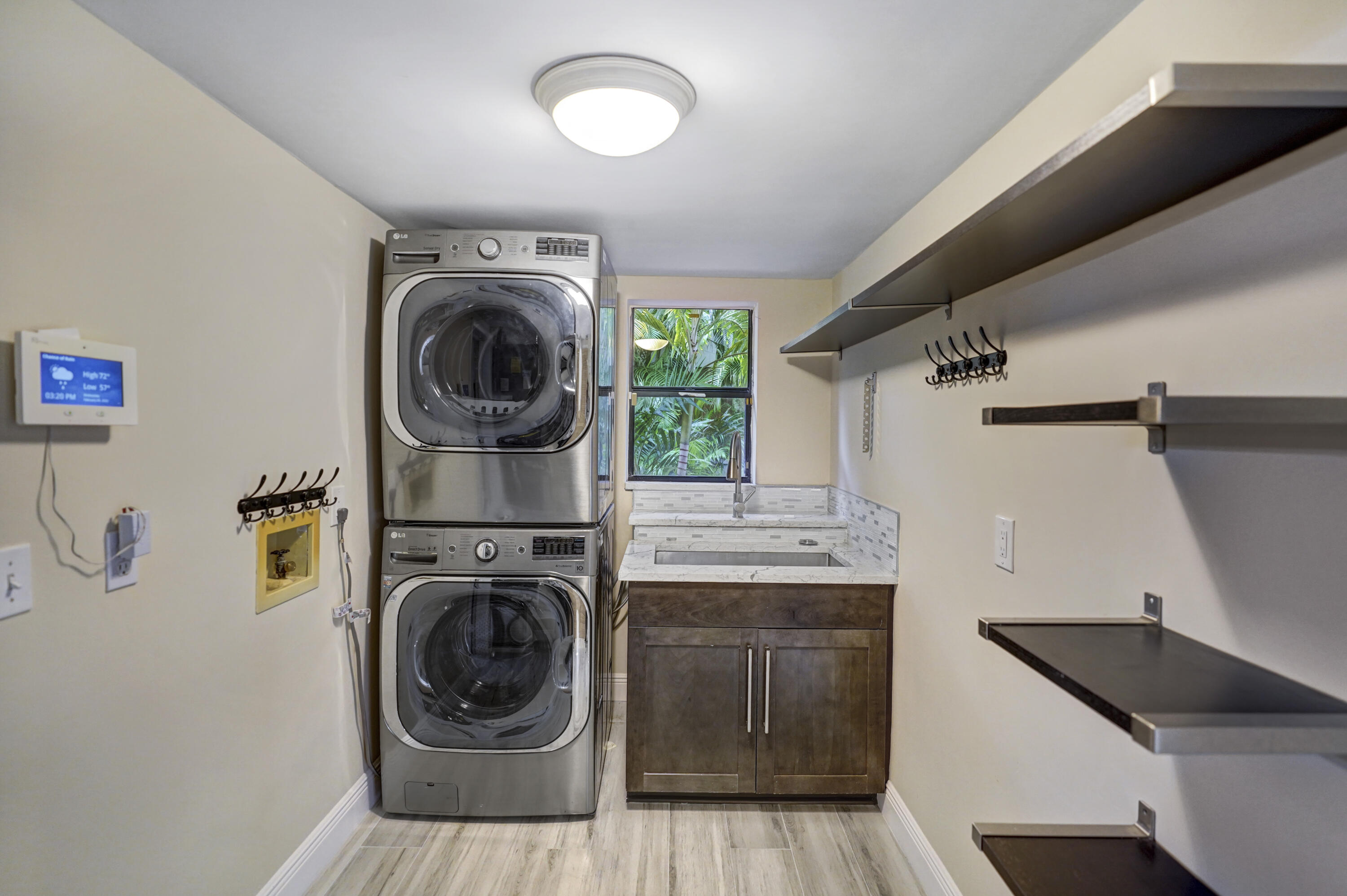 2674 Northwest 41st Street Boca Raton, FL 33434 - Photo 24 of 48 a view of a storage and utility room with washer and dryer