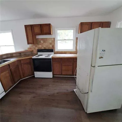 a kitchen with a refrigerator and a sink