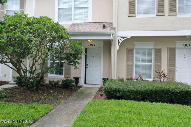 an aerial view of a house with garden space and a lake view