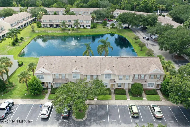 an aerial view of a house with a yard and garden