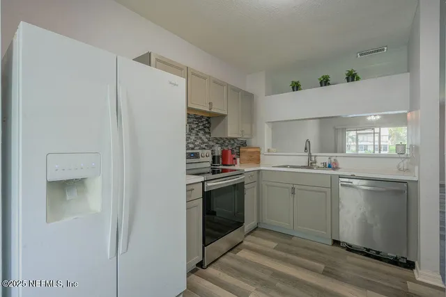 a kitchen with a stove and a refrigerator