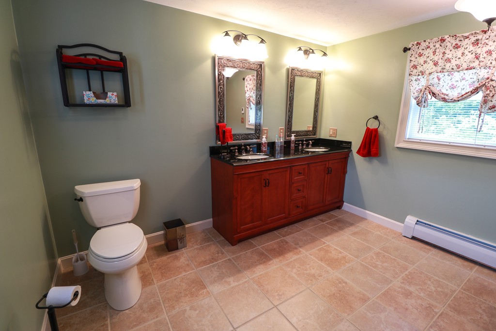 55 Mason Road Dudley, MA 01571 - Photo 7 of 19 a bathroom with a toilet a sink and a mirror