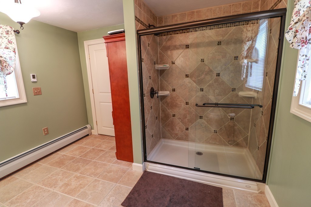55 Mason Road Dudley, MA 01571 - Photo 8 of 19 a bathroom with a glass shower door