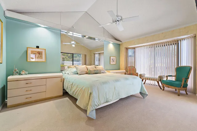 a spacious bedroom with a bed and a furniture