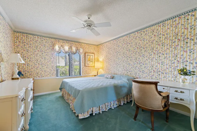 a bedroom with a bed chair and window