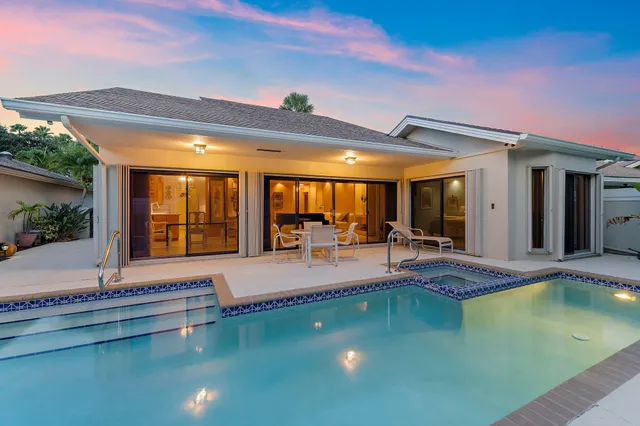 a view of a patio with swimming pool table and chairs