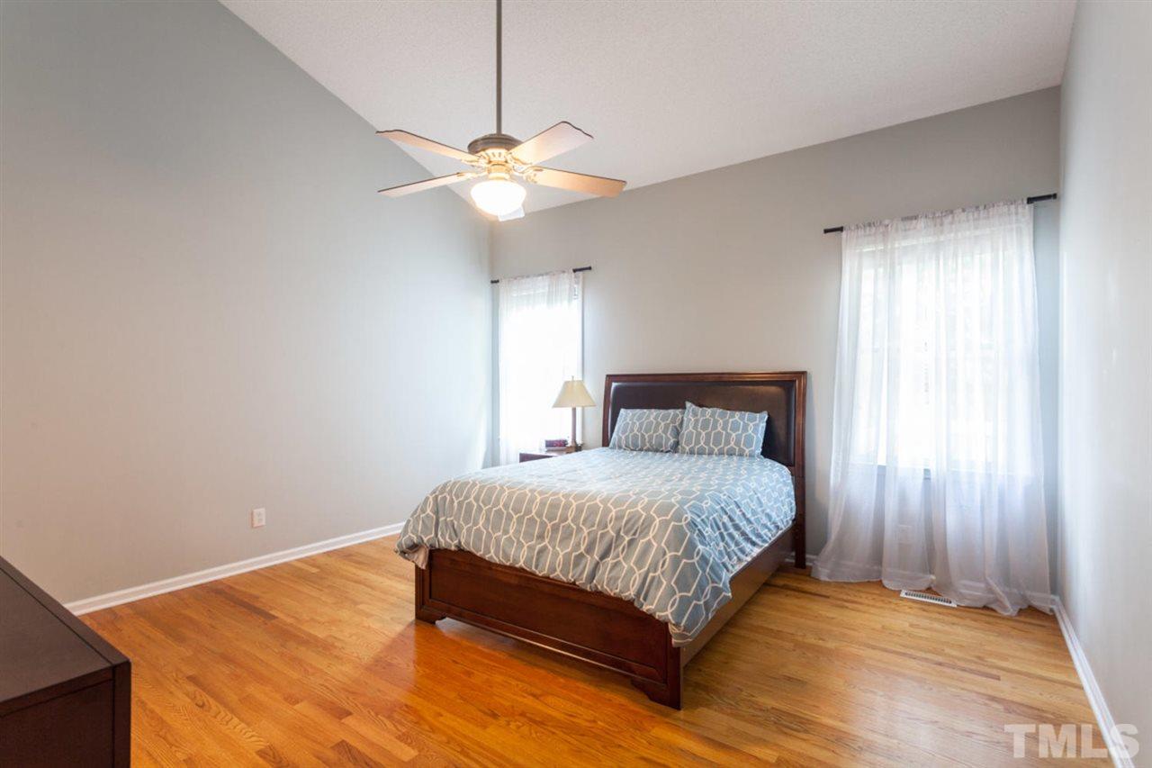 2337 Florida Court Raleigh, NC 27615 - Photo 12 of 25 a bedroom with a large bed and a chandelier