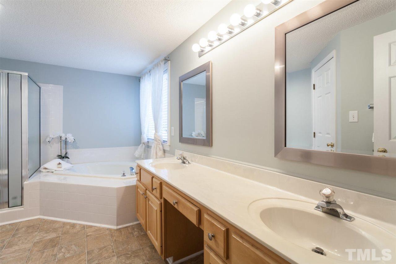 2337 Florida Court Raleigh, NC 27615 - Photo 14 of 25 a bathroom with a sink double vanity mirror and bathtub