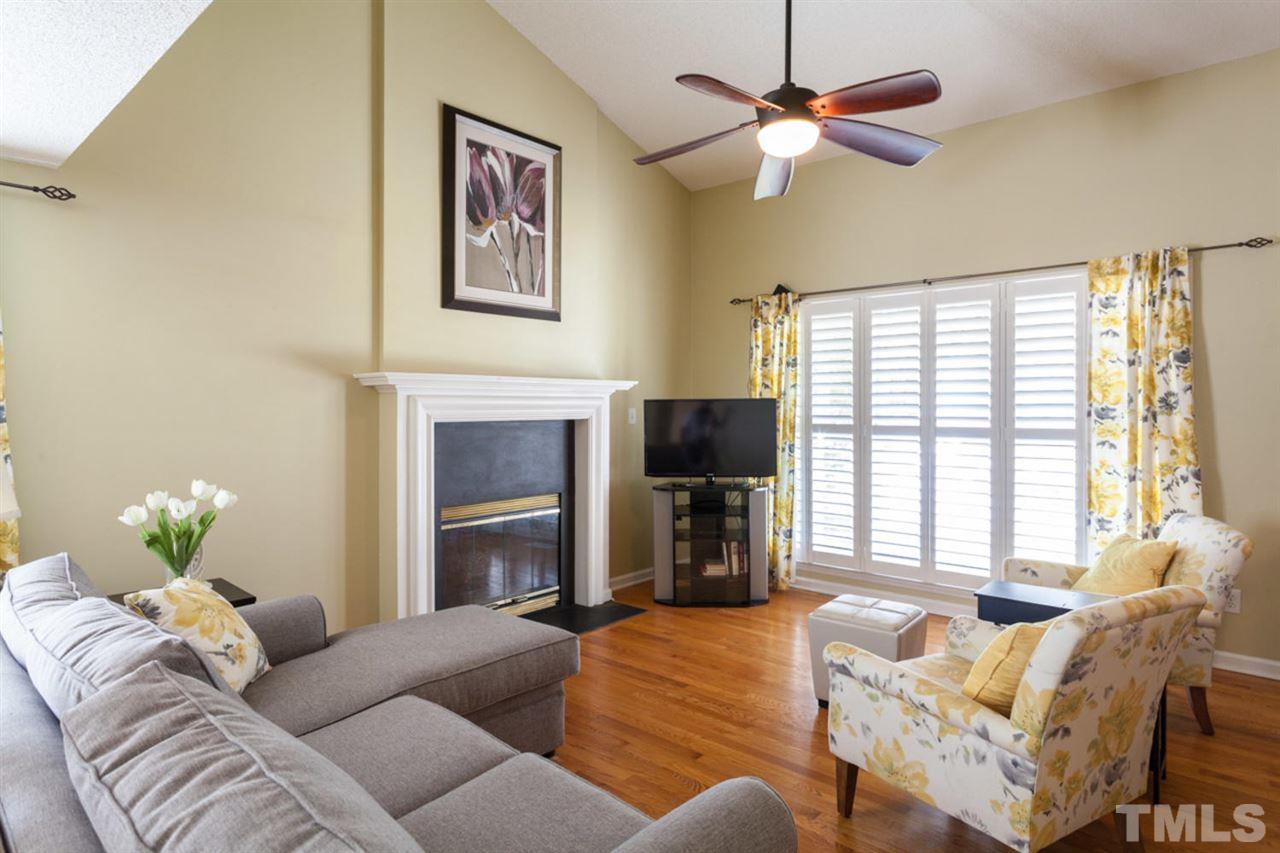2337 Florida Court Raleigh, NC 27615 - Photo 3 of 25 a living room with furniture a fireplace and a flat screen tv