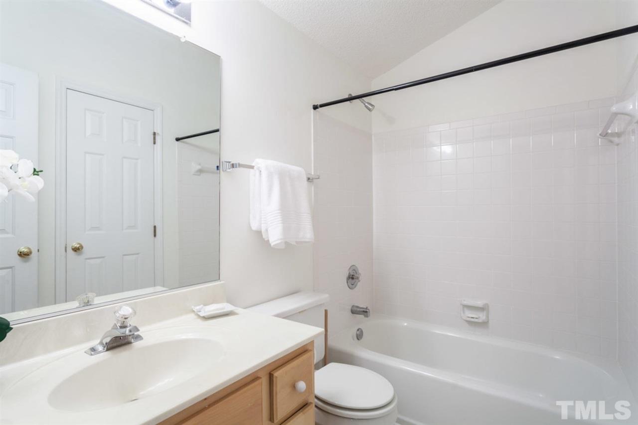 2337 Florida Court Raleigh, NC 27615 - Photo 22 of 25 a bathroom with a sink mirror toilet and bathtub