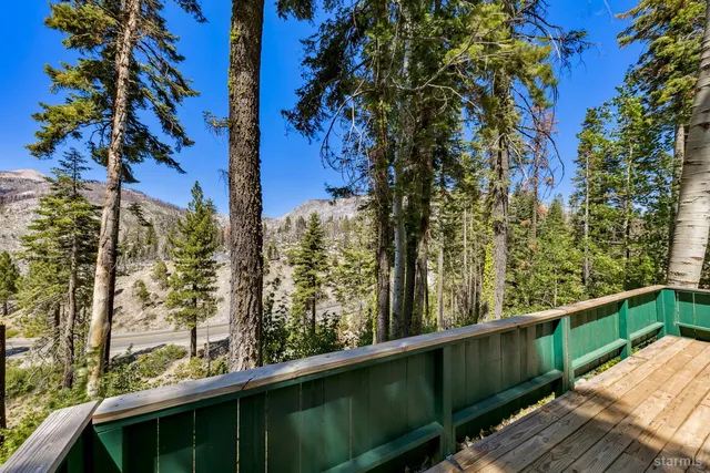 a view of a balcony with wooden fence and floor
