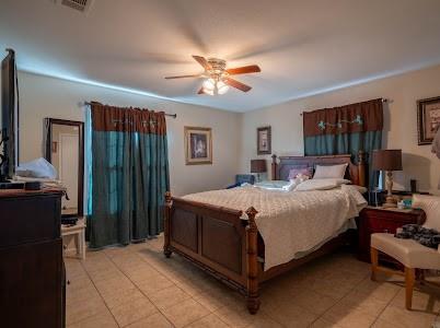 2133 Pleasant Drive Dallas, TX 75227 - Photo 31 of 40 Bedroom with a ceiling fan and light tile patterned flooring