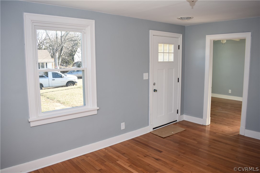 550 Riverview Road Colonial Heights, VA 23834 - Photo 3 of 26 an empty room with wooden floor and windows