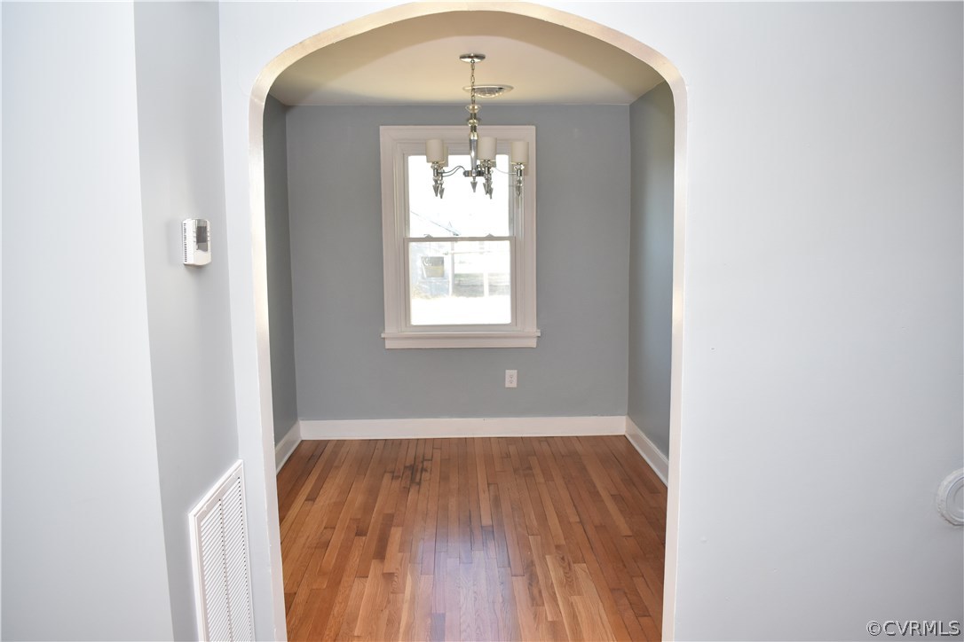 550 Riverview Road Colonial Heights, VA 23834 - Photo 6 of 26 an empty room with wooden floor and windows