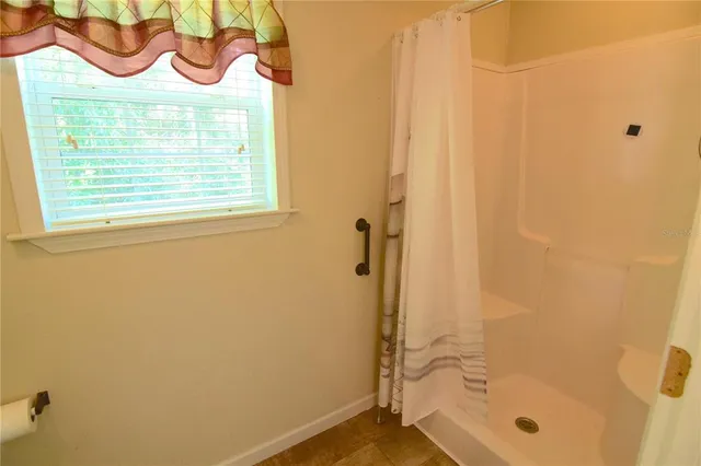a bathroom with a toilet and a window