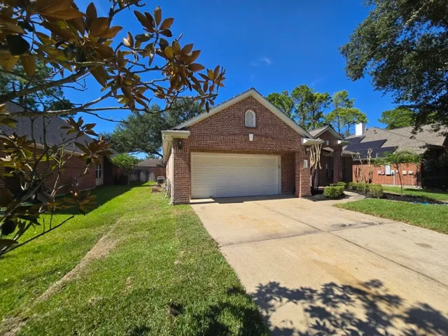 a front view of a house with a yard and a garage