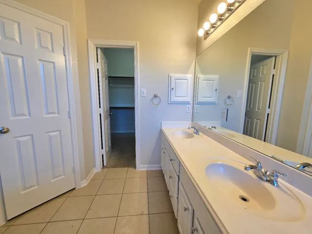a bathroom with a sink a vanity and a mirror