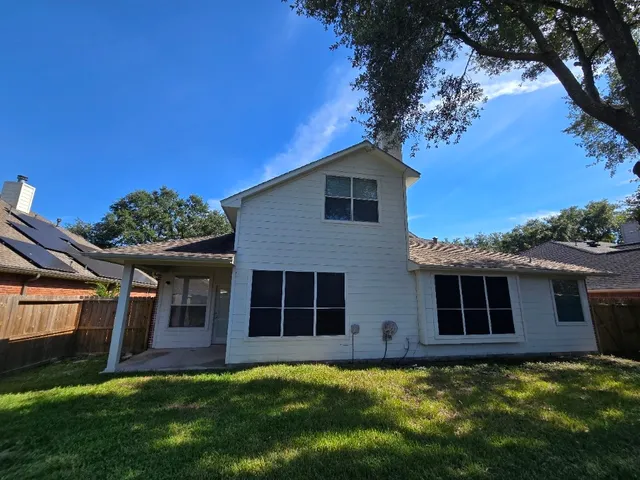 a large tree in front of a house