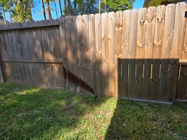 a view of a backyard with wooden fence
